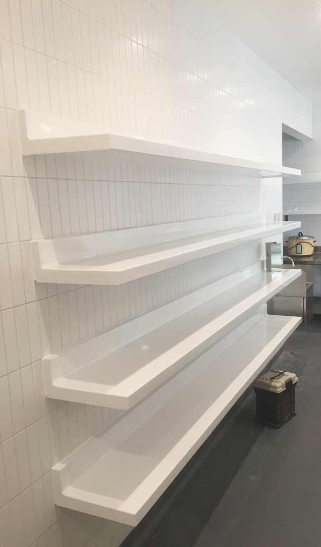 White Powder Coated Cantilever Shelves Over White Tile Wall
