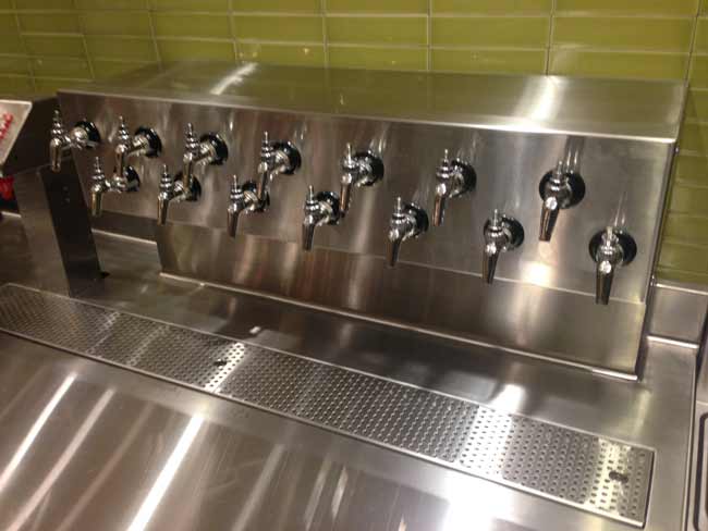 Custom fabricated beer tower assembly integrated into beverage counter