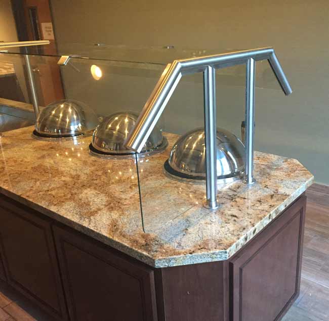 Custom designed and built stainless steel sneeze guards for Socal Hotel